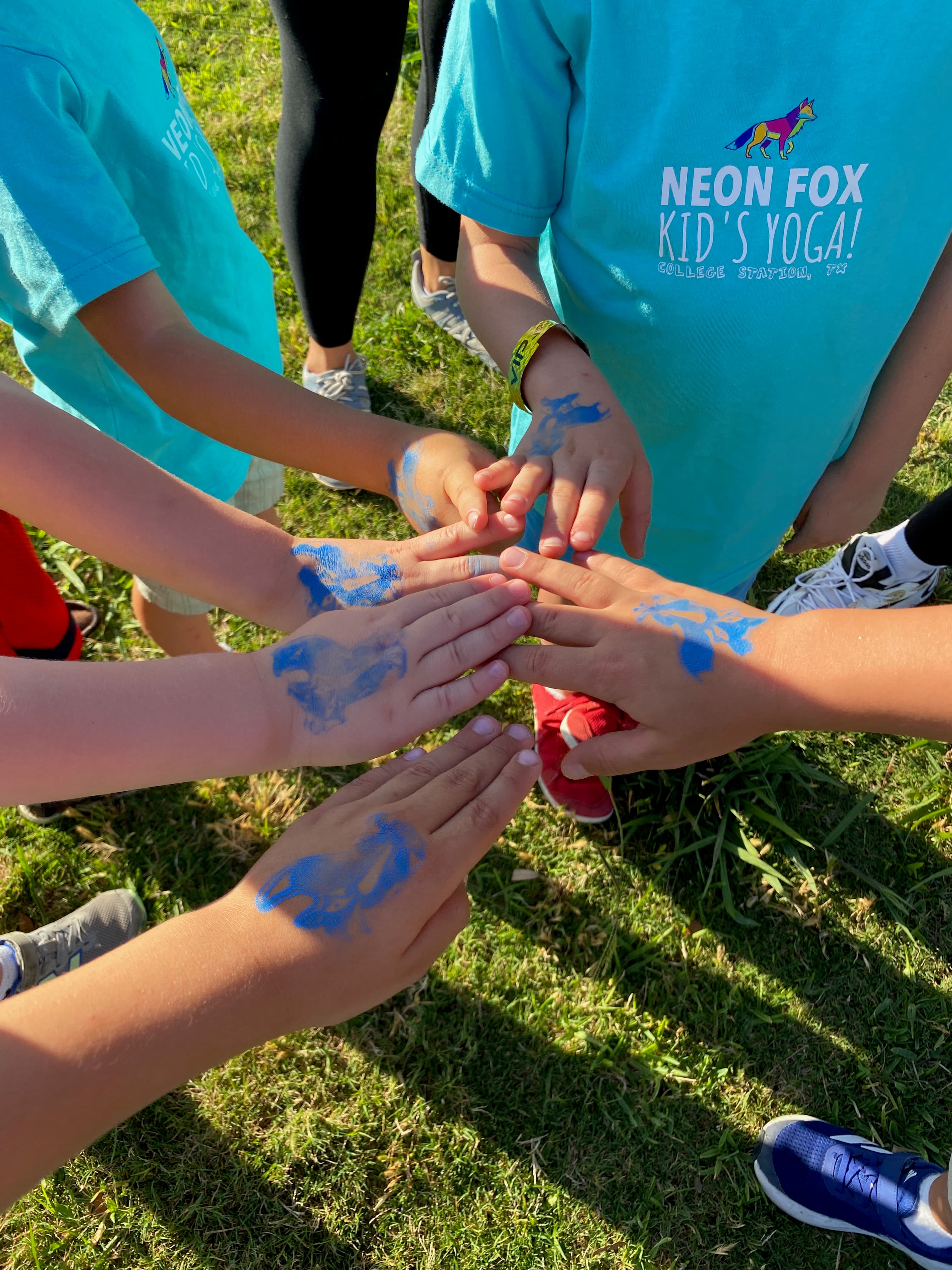 Kids showing Neon Fox animal stamps on their hands